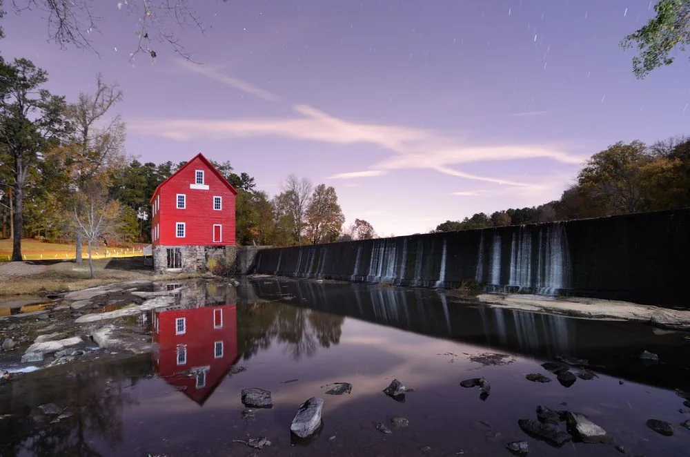 A red barn reflected in a still pond near Fayetteville, GA